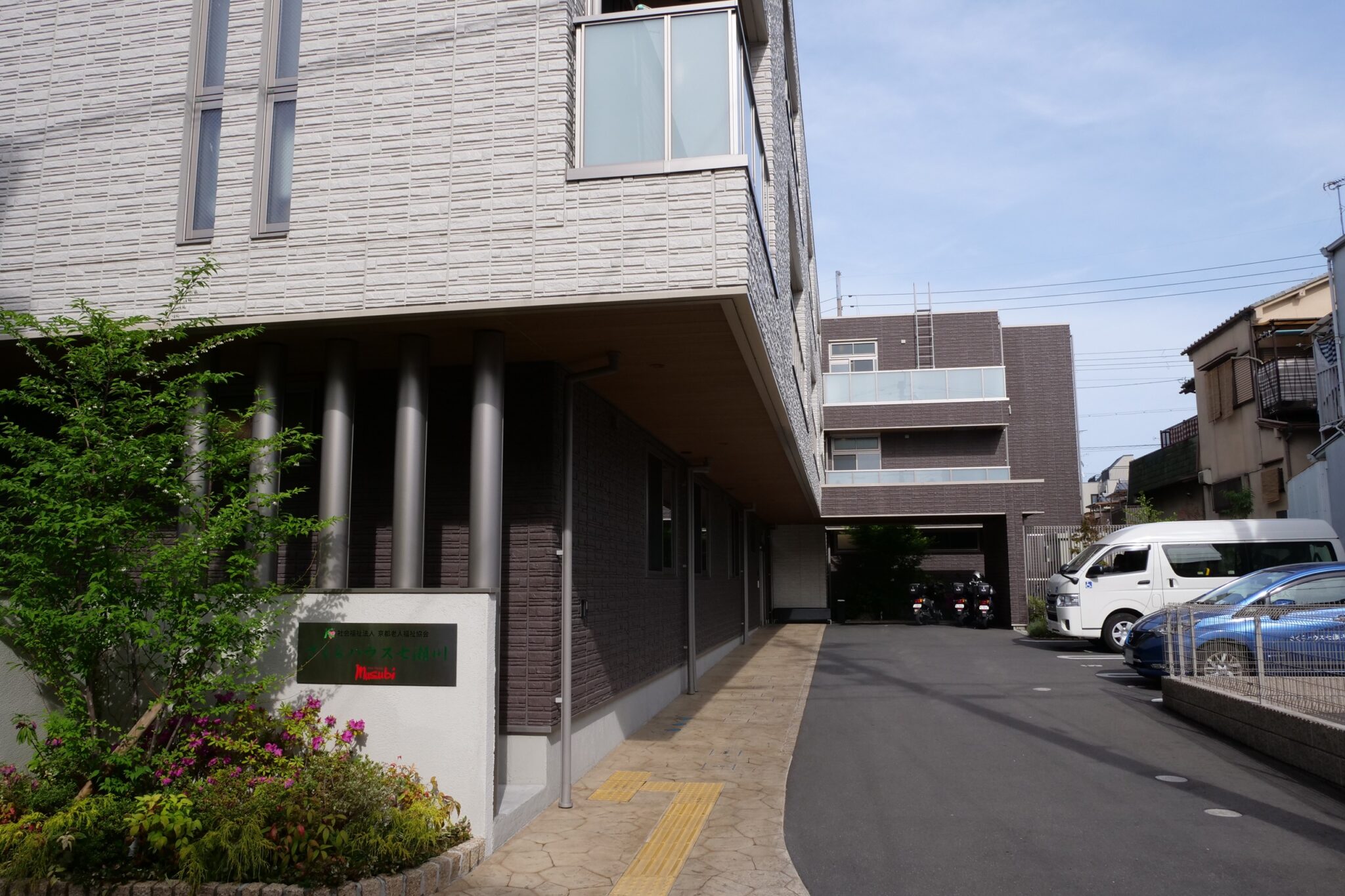 介護施設の玄関・エントランス。ブロック造りの建物で車寄せを備えている。